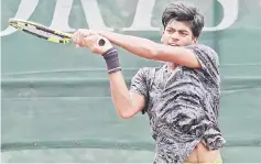  ??  ?? Darrshan Suresh hits a return to Oskar Bostrom Poulsen of Denmark in the boys singles second round at SLTA Tennis Centre yesterday. He won 6-1, 1-6, 6-3 and next faces Chinese Taipei’s Chang Tzu Li.