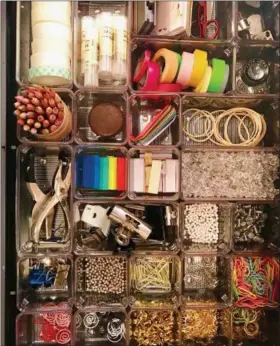  ?? DARCY MILLER — WWW.DARCYMILLE­RDESIGNS.COM VIA AP ?? This undated photo provided by Darcy Miller shows one of her crafting drawers filled with tiny containers holding everything from color-coded paperclips to washi tape — some of the items she reaches for most.