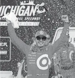  ?? [AP PHOTO] ?? Kyle Larson celebrates winning the NASCAR Cup Series auto race in Brooklyn, Mich., on Sunday.