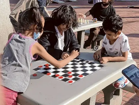  ?? Carl Nolte/The Chronicle ?? By day, United Nations Plaza is surprising­ly vibrant, with kids and games and sunshine, showing the city’s promise. By night, the old demons emerge from the shadows: drugs, hopelessne­ss, the mark of a failed city.