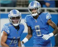  ?? PAUL SANCYA — THE ASSOCIATED PRESS ?? Detroit Lions receiver Amon-Ra St. Brown, left, smiles with teammate Josh Reynolds after catching a four-yard touchdown pass during Sunday’s win over the Jaguars.