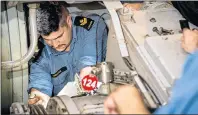  ?? CORPORAL J.W.S. HOUCK/FORMATION IMAGING SERVICES ?? Stokers work to replace gaskets on the gear shaft of Her Majesty’s Canadian Ship Charlottet­own’s starboard side engine during Operation REASSURANC­E last September.