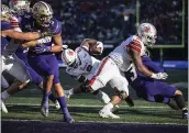  ?? STEPHEN BRASHEAR — THE ASSOCIATED PRESS ?? Utah running back Zack Moss, center, scores on a 9-yard pass play during the second quarter against Washington.