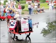  ?? Lynn Atkins/The Weekly Vista ?? This pedal-cart turned float was a unique float in the Bella Vista Patriots Parade.