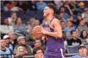  ??  ?? Suns guard Devin Booker (1) laughs after stepping out of bounds in the second half against the Grizzlies.