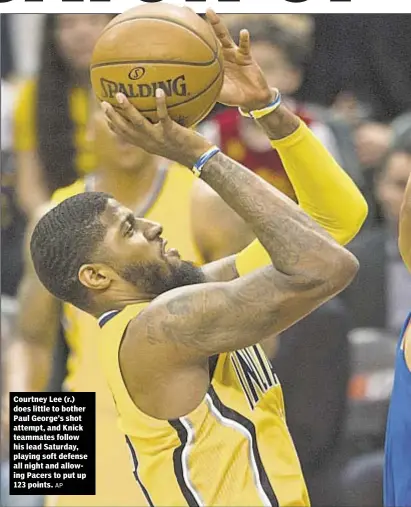  ?? AP ?? Courtney Lee (r.) does little to bother Paul George’s shot attempt, and Knick teammates follow his lead Saturday, playing soft defense all night and allowing Pacers to put up 123 points.