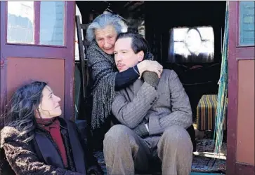  ?? Under the Milky Way ?? DJANGO Reinhardt (Reda Kateb) gets a hug in new biopic. With Béata Palya, left, and BimBam Merstein.