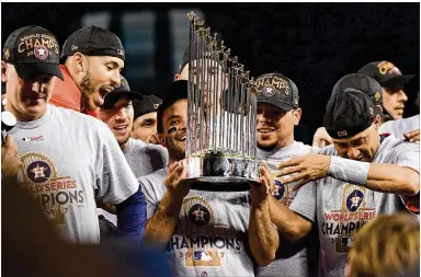  ?? GETTY IMAGES ?? Astros second baseman Jose Altuve, holding the Commission­er’s Trophy on Wednesday after Houston won Game 7 of the World Series, is part of what may be the best infifield in baseball, with Altuve likely to be American League MVP.