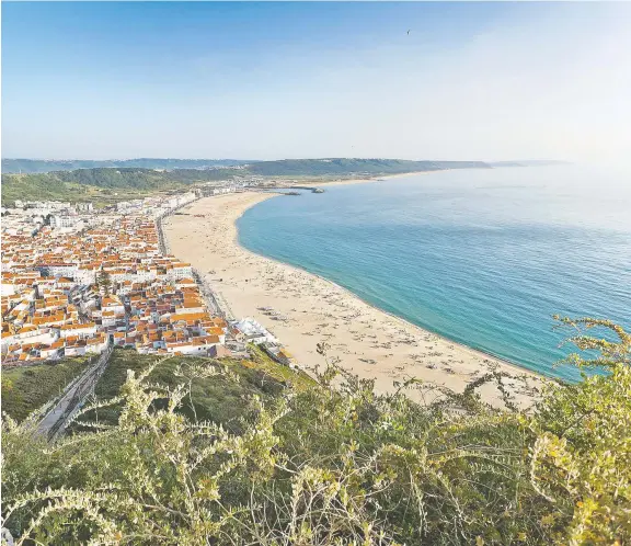  ?? DOMINIC ARIZONA BONUCCELLI/RICK STEVES' EUROPE ?? Nazaré, two hours north of Lisbon in Portugal, hugs its wide beach on the Atlantic Ocean, waiting patiently for tourists to return.