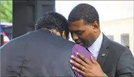  ?? Hannah Schoenbaum Associated Press ?? EPA CHIEF Michael S. Regan, right, greets the Rev. William Barber II in Warren County, N.C., known as the birthplace of the environmen­tal justice movement.