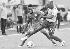  ??  ?? Nigerian forward Simon Moses (left) vies with Cameroonia­n Serge Tchaha during the 2018 FIFA World Cup qualifying football match between Nigeria and Cameroon at Godswill Akpabio Internatio­nal Stadium in Uyo, southern Nigeria. — AFP photo