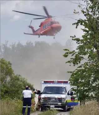  ?? JOHN RENNISON, THE HAMILTON SPECTATOR ?? An air ambulance lifts off from a park mid-afternoon Tuesday, after a swimmer was pulled from the water with no vital signs by fellow workers at a staff party. They are credited with performing CPR until paramedics arrived.