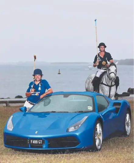  ??  ?? Polo players Beau Skerrett (left) and Mark Lillyman share the spotlight with a Ferrari at the Spit. Picture: GLENN HAMPSON