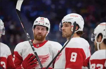  ?? JOHN FROSCHAUER — THE ASSOCIATED PRESS ?? Detroit Red Wings defenseman Jeff Petry, left, talks with Detroit Red Wings defenseman Ben Chiarot before a face-off against the Seattle Kraken during the second period of Monday’ game in Seattle.