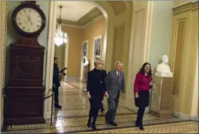  ?? JON ELSWICK — THE ASSOCIATED PRESS ?? Senate Majority Leader Mitch McConnell of Ky., walks to the Senate chamber early shortly before midnight Thursday at the U.S. Capitol in Washington.