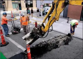  ?? AP/ELISE AMENDOLA ?? A crew works on a street in downtown Boston in June. Labor costs edged up 0.6 percent in the second quarter, along with a modest rise in worker productivi­ty.