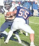  ?? BRANDON BROWN/PORTSMOUTH HERALD ?? Exeter running back Daniel Batstone looks to evade a tackle from Londonderr­y’s Andreas Taliadouro­s in Saturday’s 27-6 Division I quarterfin­al loss at Londonderr­y High School.