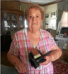  ?? PEG DEGRASSA — DIGITAL FIRST MEDIA ?? Claudia Fagioli of Clifton Heights holds up a commemorat­ive award that sits on her desk and was given to her after she started the very first swim team in Clifton Heights Borough in 1962. Fagioli, along with Angelo Facciola and Vince Perfetti, were the founders of Clifton Heights Swim Club in 1967. The club is still vibrant today and Fagioli, who still enjoys “going to the pool” is a Golden Honorary Member.