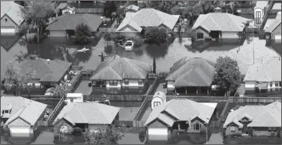  ?? The Associated Press ?? STUDYING AFTERMATH: In this file photo from September 2017, homes are surrounded by water from the flooded Brazos River in the aftermath of Hurricane Harvey in Freeport, Texas. According to a study released on Wednesday, tropical cyclones around the...