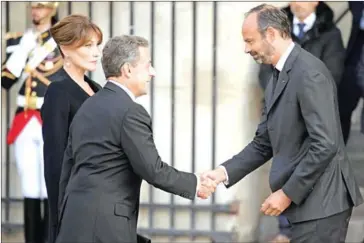  ?? ERIC FEFERBERG/AFP ?? Former French president Nicolas Sarkozy (centre) is greeted by French Prime Minister Edouard Philippe as he arrives with his wife Carla Bruni-Sarkozy to attend a church service for former French president Jacques Chirac on Monday.