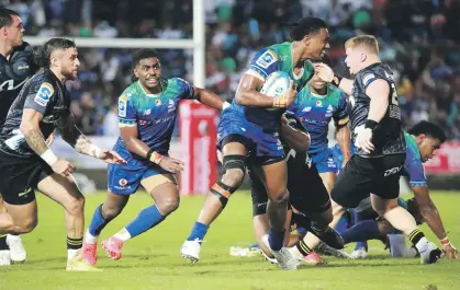  ?? GETTY IMAGES ?? The Hurricanes try to shut down Drua midfielder Iosefo Masi in Suva during their Super REugby Pacific match ilast night.