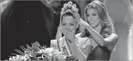  ?? John Locher / AP ?? Former Miss Universe Iris Mittenaere, right, crowns new Miss Universe Demi-Leigh Nel-Peters at the Miss Universe pageant.