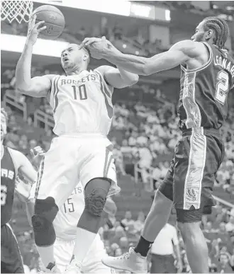  ?? Karen Warren / Houston Chronicle ?? Encounteri­ng Kawhi Leonard was part of a tough night for Rockets guard Eric Gordon, left, who hit 3-of-10 shots for nine points during a 102-93 loss Friday night at Toyota Center.