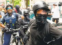  ?? ANDREW CABALLERO-REYNOLDS GETTY IMAGES ?? Rumors pushed on social media include reports claiming antifa is sending buses or even planes full of antifa activists to agitate protesters and spread violence.
