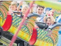  ?? ANDREW VAUGHAN/THE GUARDIAN ?? Prime Minister Justin Trudeau and his four-year-old son Hadrien ride a roller coaster as they attend the Old Home Week fair in Charlottet­own on Monday.
