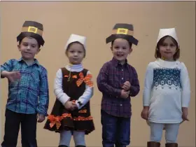  ?? SUBMITTED BY KIM CANNING ?? Children dressed as pilgrims perform for the audience during their Thanksgivi­ng feast at St. Teresa of Calcutta School.