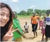  ?? PROVIDED TO CHINA DAILY ?? Ge Xinyi with locals during a study trip to Uganda.