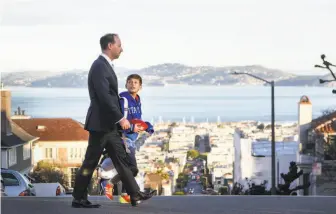  ?? Amy Osborne / Special to The Chronicle ?? San Francisco district attorney candidate Joe Alioto Veronese walks his son, Augustus Alioto Veronese, 10, to school. Veronese has name recognitio­n but little in his campaign coffers.