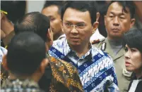  ?? (Reuters) ?? BASUKI TJAHAJA PURNAMA (center) confers with his lawyers after a guilty verdict for blasphemy was handed down in a Jakarta courtroom yesterday.