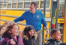  ?? SEAN D. ELLIOT/THE DAY ?? Scott Fain, principal of Wequonnoc Magnet School in Norwich, helps load students onto buses Friday for a field trip. He is retiring at the end of this school year.