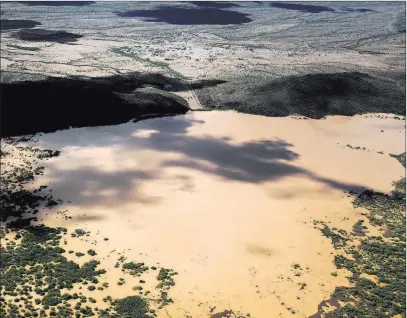  ?? Mike Christy ?? The Associated Press The earthen Menagers Dam that was in imminent danger of failing, potentiall­y sending floodwater­s rushing into the Tohono O’odham village of Ali Chuk, has held steady as the lake behind it receded on Wednesday southwest of Sells, Ariz.