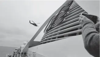  ?? Michele Smith, via The Associated Press ?? A Coast Guard helicopter delivers virus testing kits to the Grand Princess cruise ship Thursday off the California coast.