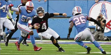  ?? AP ?? Atlanta’s backup QB Taylor Heinicke, who came in and got the offense moving as starter Desmond Ridder was being checked out, scrambles as the Titans’ Harold Landry III (58) and Kristian Fulton defend in Sunday’s game.