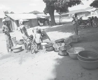  ??  ?? Women and children queuing for water at a borehole in Sabo village in Kuje Area Council.