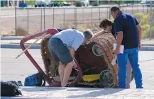  ??  ?? Federal officials on Sunday examine the balloon gondola at Central and Unser where four passengers and the pilot were fatally injured in a crash on Saturday.