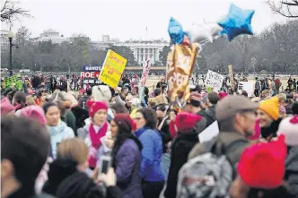  ?? [AP FILE PHOTO] ?? Protesters walk across Constituti­on Avenue near the White House for the Women’s March on Washington during the first full day of Donald Trump’s presidency Jan. 21 in Washington. The American Civil Liberties Union said it is suddenly awash in donations...