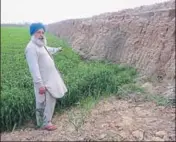  ?? HT ?? ■ Swaran Singh, a local farmer, showing the scarred landscape after the illegal mining near Janer village in Moga district.