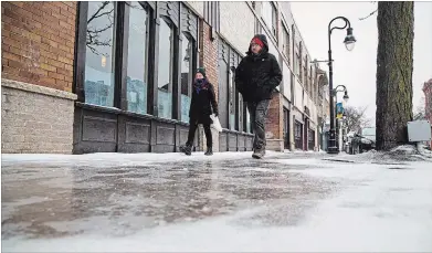  ?? JULIE JOCSAK
THE ST. CATHARINES STANDARD ?? People tread cautiously in downtownSt. Catharines after more messy winter weather Tuesday.