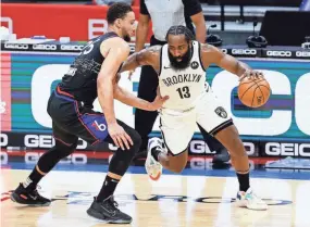  ?? TIM NWACHUKWU/GETTY IMAGES ?? James Harden (13) of the Brooklyn Nets and Ben Simmons of the Philadelph­ia 76ers traded places in the biggest deal of the season, two people with knowledge of the trade told USA TODAY Sports.