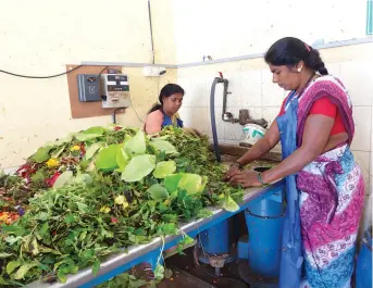  ??  ?? Workers feed segregated garbage into a biomethani­sation plant at Bengaluru's K R Puram vegetable market. The municipal corporatio­n has recently set up six such plants in the city