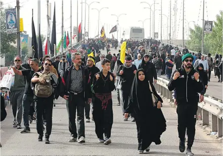  ?? HADI MIZBAN, THE ASSOCIATED PRESS ?? Shiite pilgrims march to their holy shrines at Arbaeen, outside Karbala, Iraq. Millions of Shia Muslims from around the world made the journey to honour their saints Hussein and Abbas.