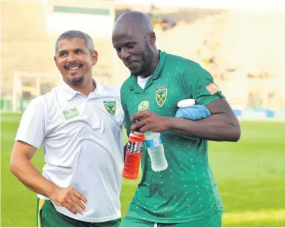  ?? Picture: Gallo Images ?? ALL SMILES. Golden Arrows coach Clinton Larsen, pictured here with Musa Bilankulu, wants his troops to believe they are capable of winning the Nedbank Cup this season.