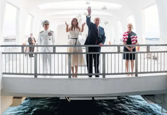  ?? AP ?? President Donald Trump and first lady Melania throw petals into the harbour above the USS Arizona’s sunken hull.