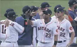  ?? ASHLEY LANDIS — THE ASSOCIATED PRESS ?? Houston Astros manager Dusty Baker Jr., left, celebrates with Michael Brantley (23), Josh Reddick (22) and others after the Astros defeated the Oakland Athletics in Game 4 of an American League Division Series in Los Angeles on Thursday.