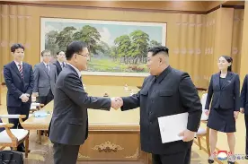  ?? Korean Central News Agency/ Korea News Service via AP ?? ■ North Korean leader Kim Jong Un, front right, shakes hands with South Korean National Security Director Chung Eui-yong after Chung gave Kim the letter from South Korean President Moon Jae-in on Monday in Pyongyang, North Korea.