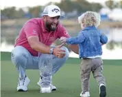  ?? (AFP) ?? Jon Rahm celebrates with son Kepa Cahill Rahm after his victory